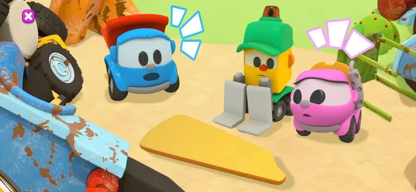 Leo the Truck, a yellow machine with a green cap and a pink truck gathered next to a yellow panel on sandy ground